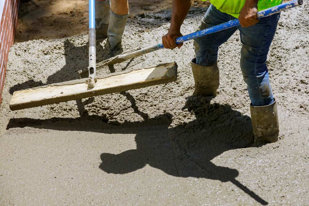Illustration of a poured concrete patio with a wheelbarrow and mixer